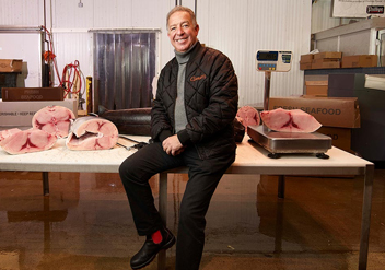 Joe Guerra sitting on table with fish