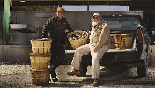 Joe Guerra in pick up truck with baskets of fresh crabs