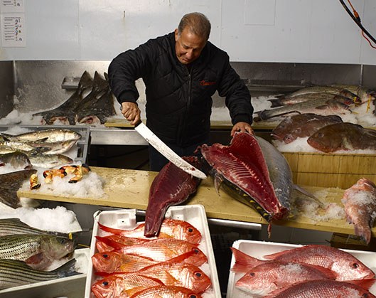 Joe Guerra with various fresh seafood cuts